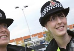 Two police constables in a shopping estate car park
