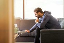 A seated person using a laptop