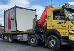 A truck transporting a porta cabin