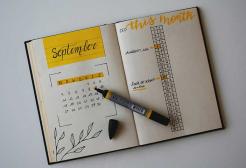 A planner book with a pen