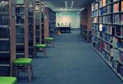 A corridor lined with bookshelves on the second floor of the Clifford Whitworth Library