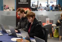 Two students working on laptops in the Library