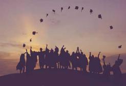 Graduates throw their caps in the air
