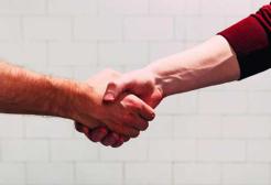 Two people shake hands