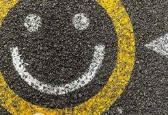 A smiley face painted on tarmac