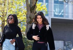 Four students walking through Peel Park campus, University of Salford