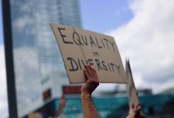 A protester holds a sign up