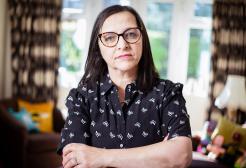 Figen Murray looks directly into the camera with her arms folded