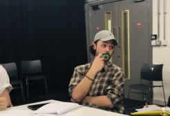 People gathered around a white table for the BBC First Homosexual rehearsal