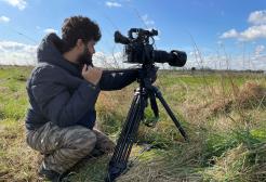 Image shows Salford graduate Ishan Vaidya filming in Skokholm