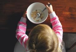 A child eating cereal from a bowl