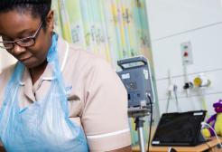 Trainee Nursing Associate (TNA) working in a hospital ward