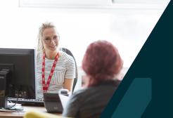 Member of support staff offering advice to a student