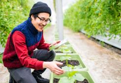 Geography degree student tending to plants