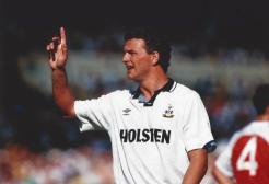 Former England player, Paul Stewart waving his hand in the air in a football match. 