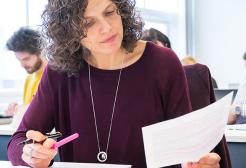 Woman looking through and assessing papers