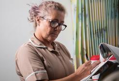A nursing apprentice looking through her notes