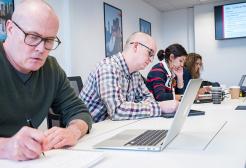 Four business apprentices doing Maths and English