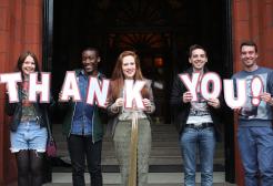 People holding letters that spell the words thank you