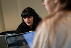 Two people working with laptops