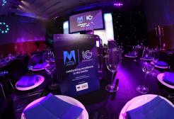 Asian Media Awards ceremony with tables, plates and glasses