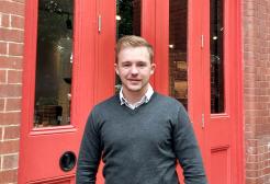 a man standing in front of a red door