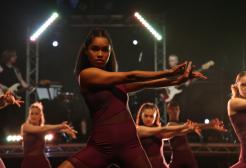 A group of contemporary dancers perform on stage