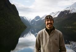 Graduate Kory Le Moore by a lake