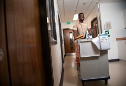 Nursing apprentice pushing a trolley in the hospital ward