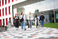 A group of students outside the Science, Engineering & Environment (SEE) Building, University of Salford