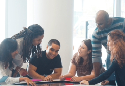 Six business students working together at a table