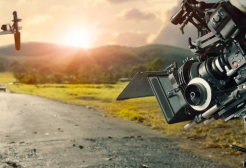 Image shows a camera and a boom mic on a track