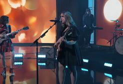 A band performs on a stage on a talk show