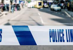 'Do not cross, police line' tape restricting street access