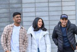 Three business school students smiling together