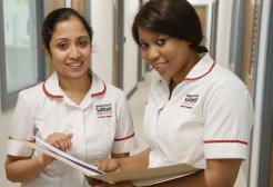 Student nurses reading patient records