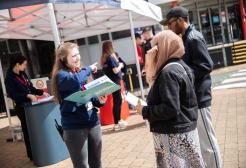 Visitors receiving information booklet on open day 
