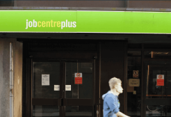 man walking past job centre 