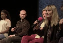 Szilvi Naray speaks into a microphone at a panel event for The Dead Man