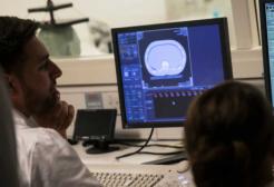 Radiography students looking at results on a computer 