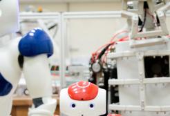 Two robots one blue slightly taller than a red robot