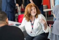 Staff and students in conversation in the Salford Business School