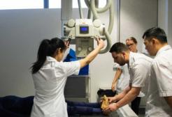 University students using machine in radiography facilities
