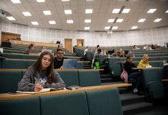 Students seated in a tiered lecture theatre