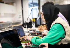 A female student working on a computer in a lab