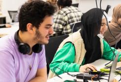 Three students working together on laptops