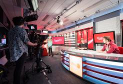 Students filming in a broadcast studio