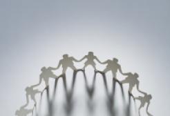 paper cut outs showing a circle of figures