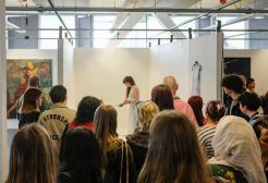 Crowd gathered to watch an exhibit at the University of Salford Degree Show 2022