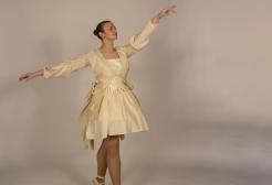 A dancer poses in a white garment